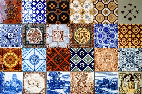 Flat lay background of 24 individual decorative ceramic tiles (azulejos), each with a unique pattern — mosaic composition, Mediterranean and Iberian tile art