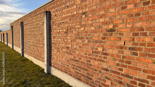 Bild auf Leinwand Prison or Camp Style Brick Wall in Germany in Golden Hour Light