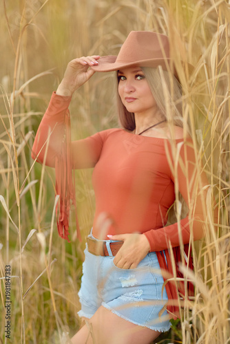 Woman portrait near tall grass outdoors