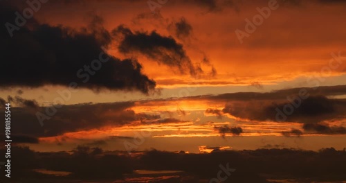 Timelapse footage of light beams among clouds in a gloomy sky covered with rain and storm clouds.