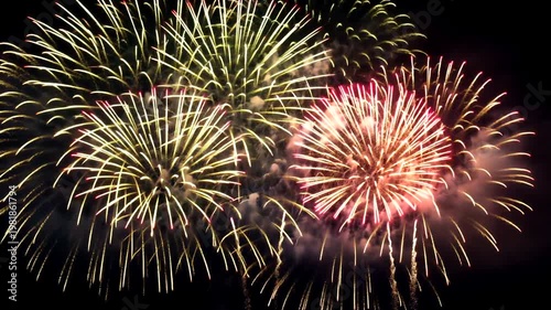 Vibrant bursts of light illuminate the night sky with radiant colors