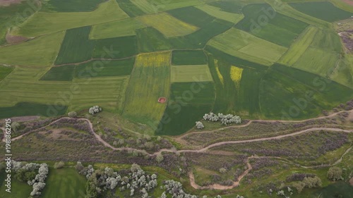 Aerial footage of large farmland with fields of corn, wheat, sunflower and cotton.