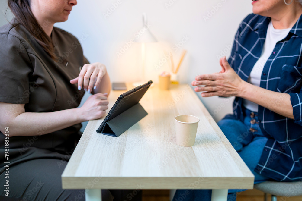 Fototapeta premium Therapist consulting client at a clinic, discussing treatment for well-being