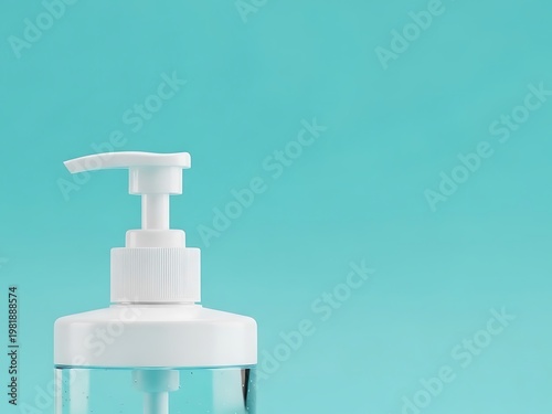 A white hand sanitizer dispenser stands on a teal background with clear liquid visible