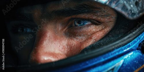 A race car driver?s face with blue eyes and detailed skin texture behind a helmet, emphasizing focus and determination in high-substance motorsport setting