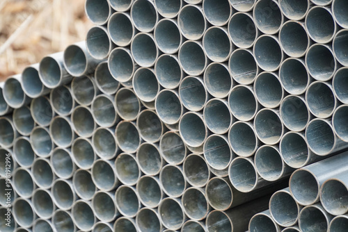 Obraz na plátne Industrial Stack of Galvanized Metal Pipes with Circular Openings at Constructio