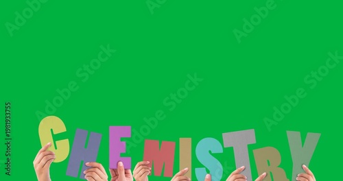 Multiple hand holding chemistry text letters against black background