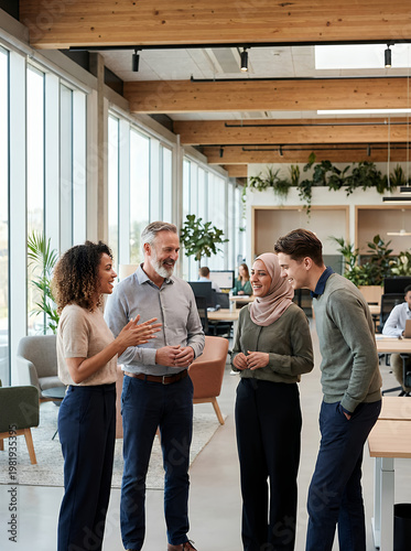 Diverse group of professionals collaborating and conversing in a bright, modern open-plan office environment, fostering teamwork and innovation