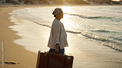 Woman stands with luggage on sandy beach at sunset ocean waves