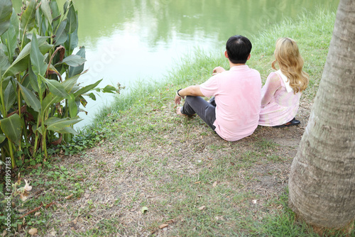 Couple Relaxing by the Pond