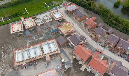 Photos A high-angle aerial photograph showing the transition between established 20th-century housing and the new-build Kingsdown development