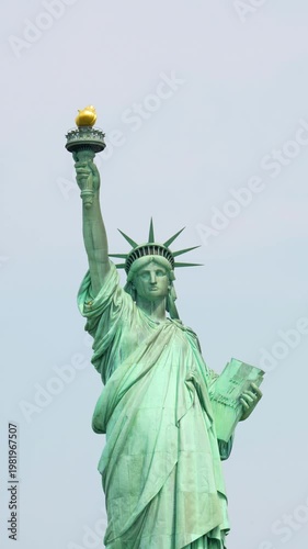 Statue of Liberty viewed from ferry boat crossing New York Harbor on sunny day