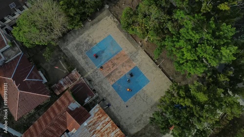Children playing with toy cars on a basketball court. The scene shows fun outdoor activity, creativity, and joyful moments of childhood in a sports environment.
