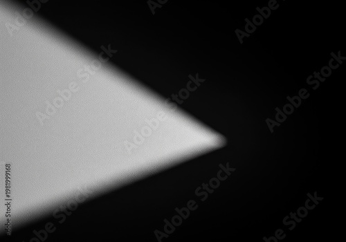 Simple monochrome abstract composition with a deep, dramatic shadow crossing a pale textured surface. Focusing on negative space, clean, shadow, design