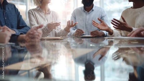Group discusses ideas in a conference room with glass walls during a work meeting