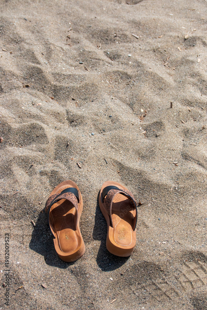 Fototapeta premium flip flops on the beach