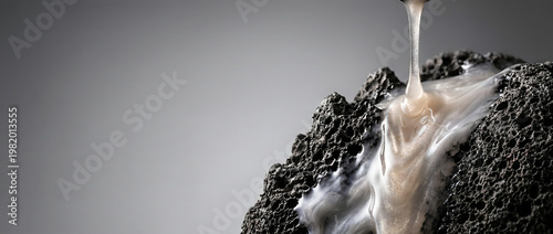 Skincare cream pouring on volcanic stone, luxury cosmetic product advertising