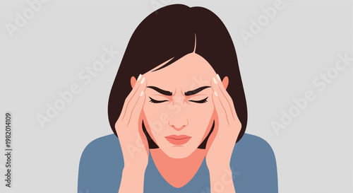 A young woman with short brown hair holding her head in pain from a headache