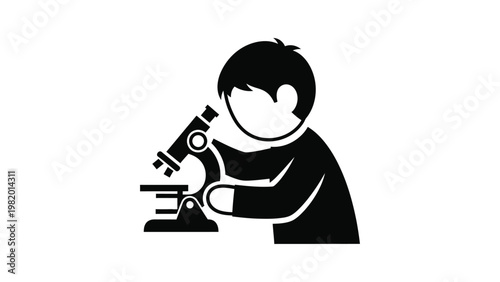 Boy looking through a microscope.