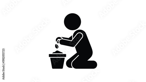 Black silhouette of a person planting a seedling.