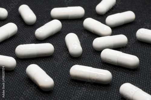 white pills on black background