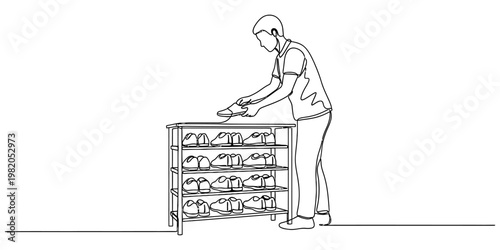 A continuous line drawing of a person carefully organizing shoes on a multi-tiered wooden rack.