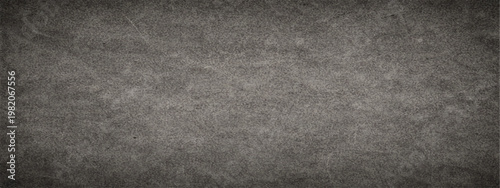 Abstract dark gray grungy surface, ideal for various design uses, with visible texture