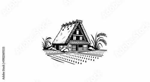 Traditional house with thatched roof stands in a rice paddy