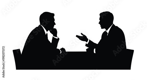 Two men in suits having a serious conversation at a table