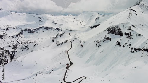 Aerial view of Grossgloknershtrasse in snow. Great high mountain road near Grossglokner mount in Austrian Alps, 4k