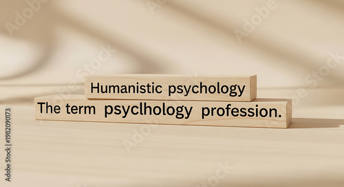 Wooden blocks with text humanistic psychology and the term psychology profession spelling out concepts related to mental health and behavioral science