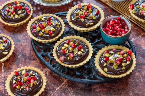 Pomegranate, pistachio and chocolate tarts
