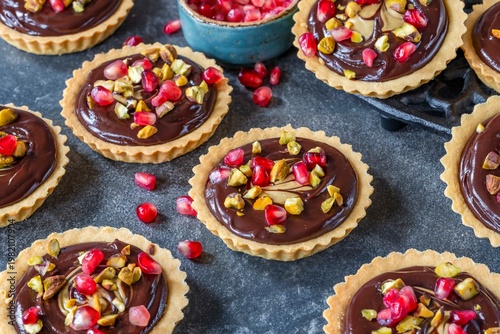 Pomegranate, pistachio and chocolate tarts