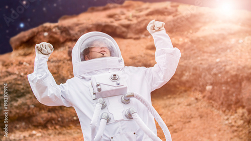 Wallpaper Mural astronaut in white space suit celebrating victory with raised fists on Mars planet surface Torontodigital.ca