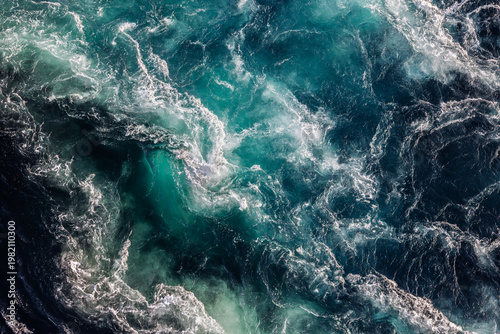 Blue waves of water of the river and the sea meet each other during high tide and low tide.