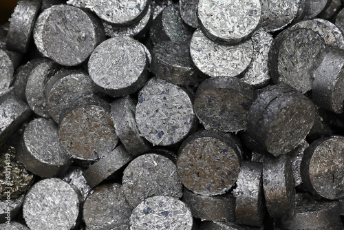 Photography Small pieces of ferrous metals are pressed into discs to make them easier to transport and handle in the recycling process