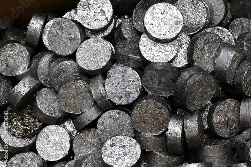 Photography Small pieces of ferrous metals are pressed into discs to make them easier to transport and handle in the recycling process