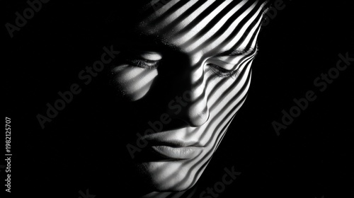 bstract black and white portrait of man face with diagonal stripe light shadow pattern overlay on dark background