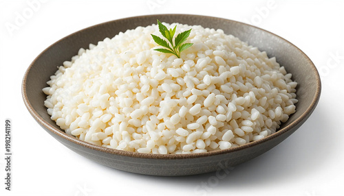 Brown ceramic bowl filled with white rice and a green leaf on top, isolated on white background