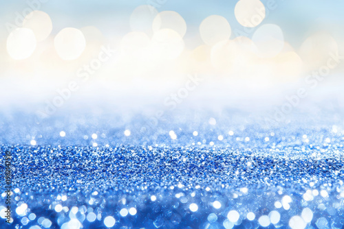 Abstract sparkling glitter effect with soft blue tones creates dreamy atmosphere, perfect for festive occasions or artistic projects