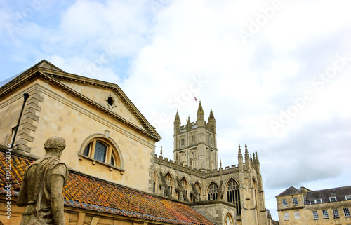 Antique Roman Baths complex and Abbey Cathedral at background in Bath, Somerset, England, UK. City of Bath is a UNESCO World Heritage Site.