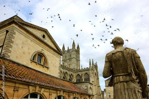 Antique Roman Baths complex and Abbey Cathedral at background in Bath, Somerset, England, UK. City of Bath is a UNESCO World Heritage Site.