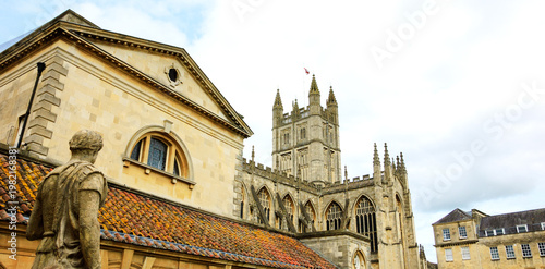 Antique Roman Baths complex and Abbey Cathedral at background in Bath, Somerset, England, UK. City of Bath is a UNESCO World Heritage Site.