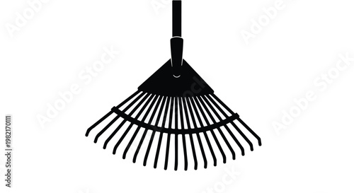 Garden rake stands isolated against a clean white background, showcasing the metal tines designed for gathering leaves and debris in an efficient manner for professional landscape maintenance.