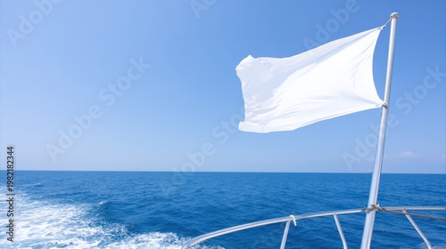 A blank flag fluttering in the wind on the back of a sailing yacht, deep blue sea background