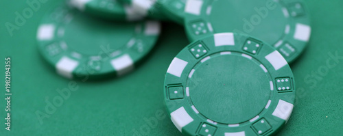 Canvas Print Green casino poker chips on green gaming table close up