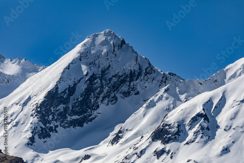 Tableau sur toile Snow-capped peaks of the French Pyrenees in the town of Génos, France, on a sunn