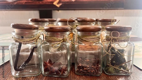 Bild auf Leinwand Glass jars hold dried spices and vanilla beans