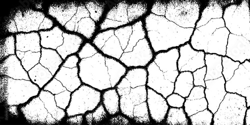  grunge texture of a cracked, weathered concrete wall in black and white monochrome. surface features intricate fracture patterns spreading organically across aged plaster.