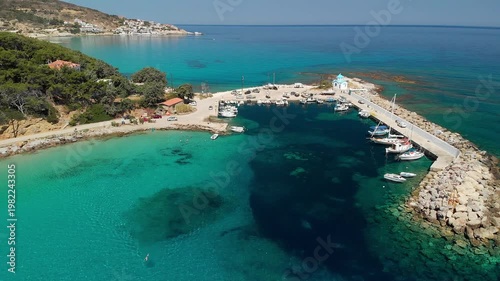 The beach and port of Gialiskari and the chapel Analipsi, Ascention in Ikaria island, Greece